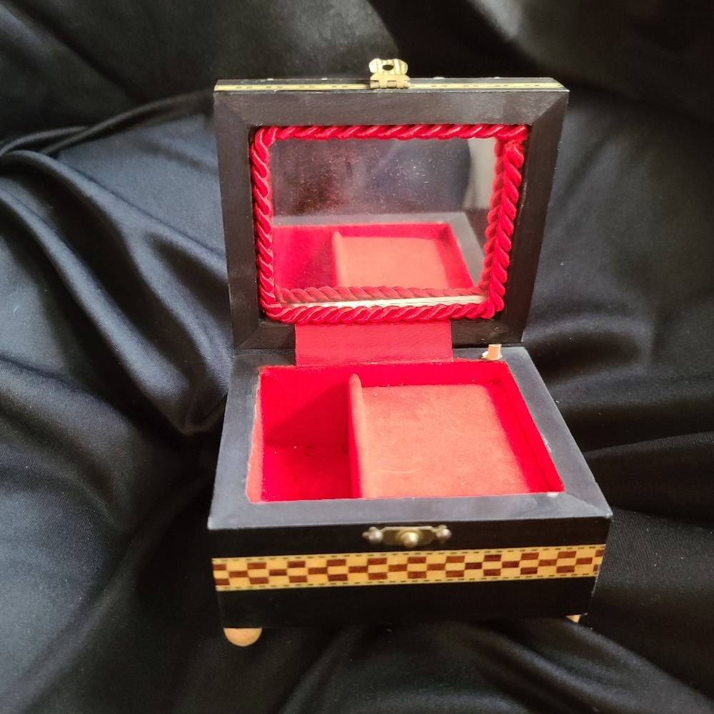 Music box..melody  unknown..Lined in red...works 3x4in